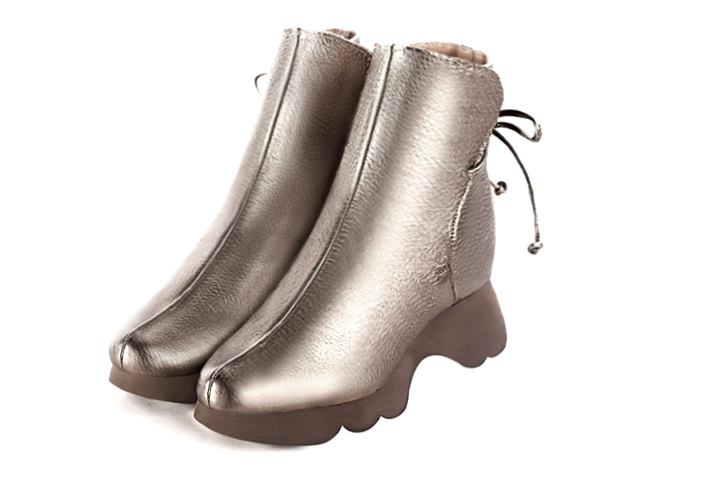 French elegance and refinement for these bronze gold dress booties with laces at the back, 
                available in many subtle leather and colour combinations. The back lacing on this charming bootie ensures a perfect fit around the ankle.
Its wedge sole will isolate you from the ground.
  
                Matching clutches for parties, ceremonies and weddings.   
                You can customize these lace-up ankle boots to perfectly match your tastes or needs, and have a unique model.  
                Choice of leathers, colours, knots and heels. 
                Wide range of materials and shades carefully chosen.  
                Rich collection of flat, low, mid and high heels.  
                Small and large shoe sizes - Florence KOOIJMAN